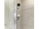Modern bathroom shower featuring gray tiling and a contemporary shower head, designed for a spa-like experience at 3027 Formia Ct, Lakewood Ranch, FL 34211