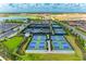Aerial view of multiple tennis courts with manicured landscaping in a vibrant community at 3027 Formia Ct, Lakewood Ranch, FL 34211
