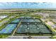 Aerial view of multiple tennis courts with manicured landscaping in a vibrant community at 3027 Formia Ct, Lakewood Ranch, FL 34211