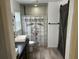 Modern bathroom featuring dual sinks, stylish wood accents, and sliding barn door at 3287 Rackley Rd, Brooksville, FL 34604