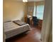 Bedroom featuring a wooden desk and a bed with striped bedding at 3287 Rackley Rd, Brooksville, FL 34604