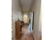 Long hallway showcasing wood-look tile flooring and neutral paint with access to all rooms at 3287 Rackley Rd, Brooksville, FL 34604