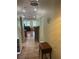 Inviting hallway with wood-look tile and view of the living room, creating a seamless transition at 3287 Rackley Rd, Brooksville, FL 34604