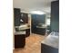 Modern kitchen featuring ample dark wood cabinetry and stainless steel appliances at 3287 Rackley Rd, Brooksville, FL 34604