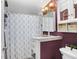 Bathroom features a shower with a patterned curtain, a white sink vanity and a medicine cabinet at 3333 26Th E Ave # 1104, Bradenton, FL 34208