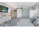 Cozy bedroom with stylish decor, including a comfortable bed, white dresser, and sliding barn door at 3333 26Th E Ave # 1104, Bradenton, FL 34208
