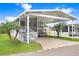 Welcoming home with a convenient carport, grill, and vibrant landscaping for a pleasing outdoor space at 3333 26Th E Ave # 1104, Bradenton, FL 34208