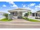 Inviting home with a covered parking area, front porch and grill, nestled among well-maintained landscaping at 3333 26Th E Ave # 1104, Bradenton, FL 34208