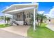 Cozy home with carport, grill, and lush landscaping, offering a comfortable and appealing exterior at 3333 26Th E Ave # 1104, Bradenton, FL 34208
