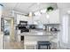 An inviting kitchen with white cabinets, stainless steel appliances, breakfast bar and tile backsplash at 3333 26Th E Ave # 1104, Bradenton, FL 34208