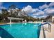 Community swimming pool surrounded by lounge chairs and well maintained landscaping at 3333 26Th E Ave # 1104, Bradenton, FL 34208