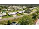 A residential neighborhood with paved roads, swimming pools, palm trees, and other greenery at 3649 Somerville Dr # 1507, Sarasota, FL 34232