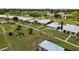 A wide aerial view of homes with lawns, palm trees, and a neighborhood street at 3649 Somerville Dr # 1507, Sarasota, FL 34232