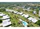 A residential neighborhood with paved roads, swimming pools, palm trees, and other greenery at 3649 Somerville Dr # 1507, Sarasota, FL 34232