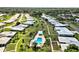 This aerial showcases the community's layout, featuring a swimming pool and lush landscaping between the villas at 3649 Somerville Dr # 1507, Sarasota, FL 34232