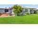Inviting backyard with patio area, mature trees, and well-maintained lawn at 3649 Somerville Dr # 1507, Sarasota, FL 34232