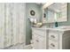 Charming bathroom featuring marble counters, a shower with curtain, and decorative accents at 3649 Somerville Dr # 1507, Sarasota, FL 34232
