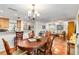 Open-concept living space showcases a dining area with chandelier and terracotta tile flooring at 3649 Somerville Dr # 1507, Sarasota, FL 34232