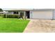 A light grey home with an attached garage and manicured lawn at 3649 Somerville Dr # 1507, Sarasota, FL 34232