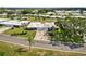 Charming home exterior with a well-manicured lawn, mature palm trees, and a paved driveway at 3649 Somerville Dr # 1507, Sarasota, FL 34232