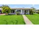 Beautiful home featuring a green lawn, manicured landscaping and concrete walkway at 3649 Somerville Dr # 1507, Sarasota, FL 34232