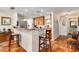 Eat-in kitchen with breakfast bar, warm cabinetry, and stainless steel appliances at 3649 Somerville Dr # 1507, Sarasota, FL 34232