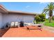 Outdoor patio with seating, a grill, and a hammock under a palm tree at 3649 Somerville Dr # 1507, Sarasota, FL 34232