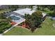 Aerial view of home showcasing screened pool, landscaping and metal roof at 3764 Oak Grove Dr, Sarasota, FL 34243