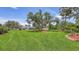 Large green backyard featuring mature trees and landscaping at 3764 Oak Grove Dr, Sarasota, FL 34243