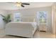 Inviting bedroom features a large white bed, two windows, and a ceiling fan at 3764 Oak Grove Dr, Sarasota, FL 34243