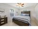 Bright bedroom featuring a wooden bed frame, neutral walls and flooring, and a charming ceiling fan at 3764 Oak Grove Dr, Sarasota, FL 34243