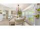 Bright dining area featuring a large window, rustic decor, and ample natural light at 3764 Oak Grove Dr, Sarasota, FL 34243