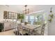 Dining room with large window for natural light, rustic decor, and a view of the backyard at 3764 Oak Grove Dr, Sarasota, FL 34243
