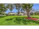 Spacious front yard featuring mature trees surrounding the home at 3764 Oak Grove Dr, Sarasota, FL 34243