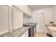 Functional laundry room with granite countertops and plenty of cabinet space at 3764 Oak Grove Dr, Sarasota, FL 34243