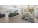 Spacious living room and dining area with tile floors, modern furniture, and a view of the lanai and pool at 3764 Oak Grove Dr, Sarasota, FL 34243