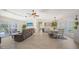 Open concept living area with tile floors, a dining area, a comfortable seating area, and sliding glass doors to the lanai at 3764 Oak Grove Dr, Sarasota, FL 34243