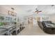 Open-concept living room and dining area showcasing neutral tones, tile floors, and modern lighting at 3764 Oak Grove Dr, Sarasota, FL 34243