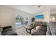 Cozy living room featuring a sliding glass door leading to the lanai, providing natural light and access to the outdoor area at 3764 Oak Grove Dr, Sarasota, FL 34243