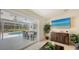 Living room with sliding glass doors to the patio, a view of the pool, and stylish furniture at 3764 Oak Grove Dr, Sarasota, FL 34243