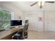 Home office with view from window, neutral tones and tiled floor at 3764 Oak Grove Dr, Sarasota, FL 34243