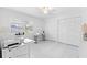 Bright bedroom with closets, sewing machines, tiled floors, and large windows with shutters at 3978 Overlook Bend Ter # 25, Sarasota, FL 34232
