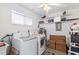 Functional laundry room with washer, dryer, shelving, and storage for household needs at 3978 Overlook Bend Ter # 25, Sarasota, FL 34232