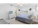 Cozy bedroom with white walls, tile floor, shuttered window, and en suite bathroom at 3978 Overlook Bend Ter # 25, Sarasota, FL 34232