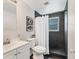 Updated bathroom with modern vanity, toilet, and tiled walk-in shower with window at 4151 Olive Ave, Sarasota, FL 34231