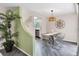 Cozy dining area with modern light fixture, stylish decor, and seamless connection to the kitchen at 4151 Olive Ave, Sarasota, FL 34231