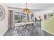 Dining room with modern table set, stylish light fixture, and screened patio view at 4151 Olive Ave, Sarasota, FL 34231