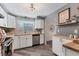 Modern kitchen features white cabinets, butcher block counters, and stainless steel appliances at 4151 Olive Ave, Sarasota, FL 34231