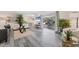 Open-concept living space with gray floors, smooth transition to dining area and screened-in patio at 4151 Olive Ave, Sarasota, FL 34231