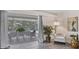 Bright living room with contemporary furniture leading to screened patio with outdoor dining at 4151 Olive Ave, Sarasota, FL 34231